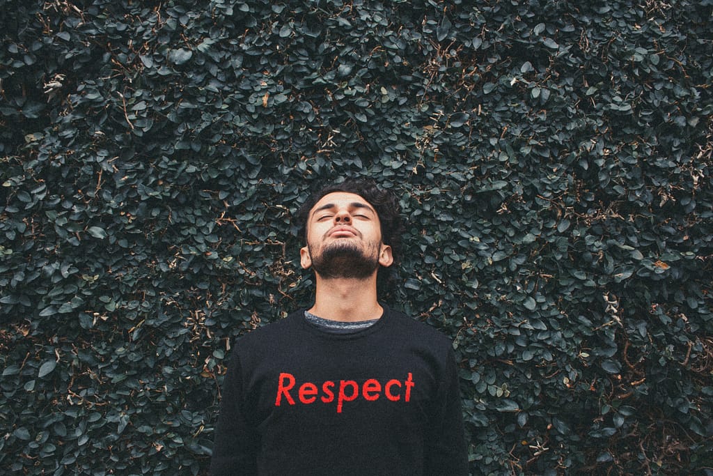 A man with a black sweatshirt with lettering "Respect" - 11 Simple Ways to Be Your Very Best