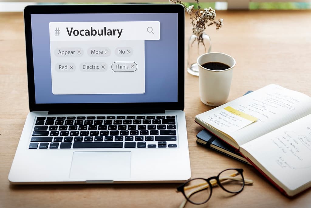 Laptop with the word Vocabulary typed on screen - Top 5 Reasons People Should Read Daily