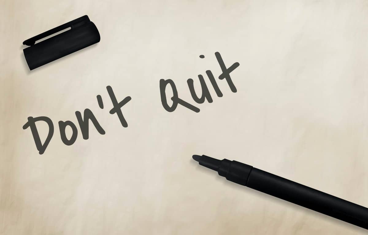 Overcome Your Job Search Blues - Whiteboard with a marker and the words "Don't Quit" - How to beat job hunting anxiety