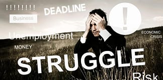 Businessman sitting in a field with hands on his face and words of struggle, deadline, finances, etc. printed all over
