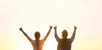 Two women with hands raised, happy with their achievement - 11 Simple Ways to Be Your Very Best