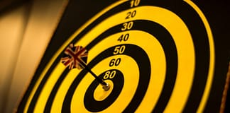 Bull's Eye with yellow dart in the center - Setting The Right Goals