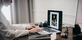 Image of woman's hands on a laptop editing an image - how to optimize images without losing quality