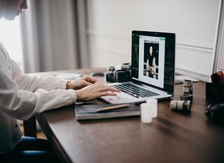 Image of woman's hands on a laptop editing an image - how to optimize images without losing quality