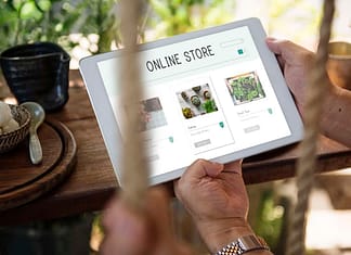 Image of man holding tablet with "Online Store" on it