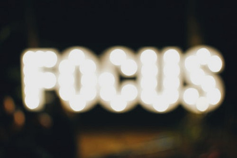 Image with blurred capital letters "FOCUS" that just mean "lack" of focus