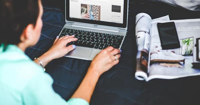 image over the shoulder of a woman blogging