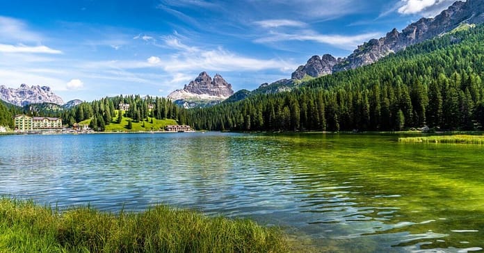 Gorgeous stock photo of river bordered by a mountain chain