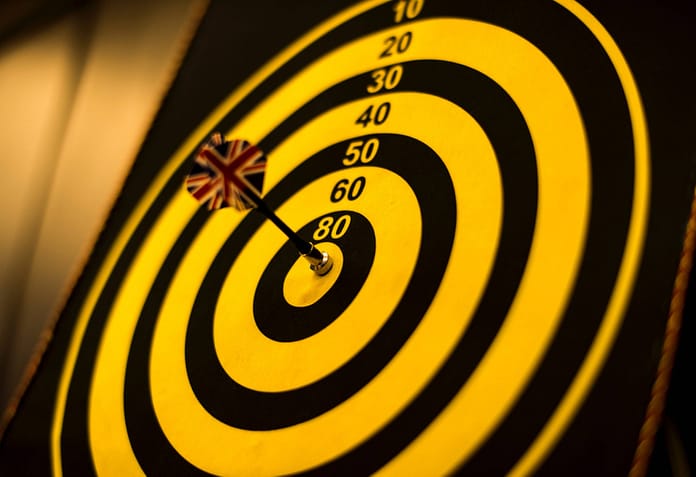 Bull's Eye with yellow dart in the center - Setting The Right Goals