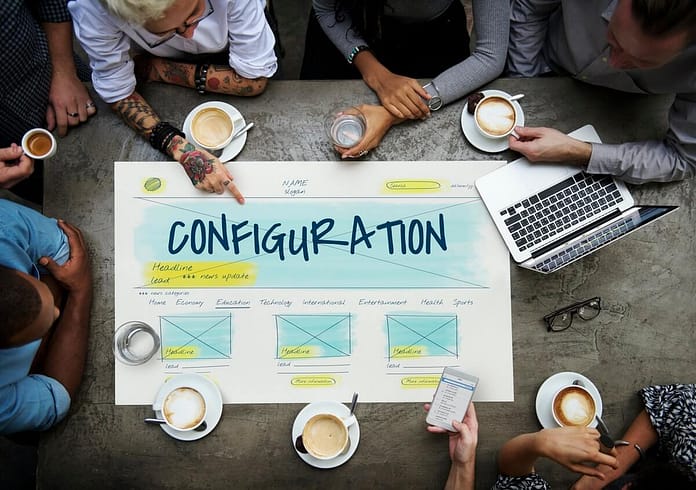 Overhead view of employees around a Configuration design chart - setting up WordPress