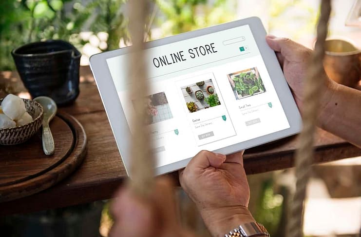Image of man holding tablet with "Online Store" on it
