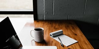 Laptop, coffee cup, notepad and phone on an oak desk - Best 3 Simple Ways To Monetize Your Blog