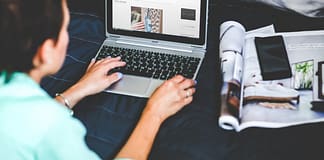 image over the shoulder of a woman blogging
