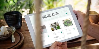 Image of man holding tablet with "Online Store" on it