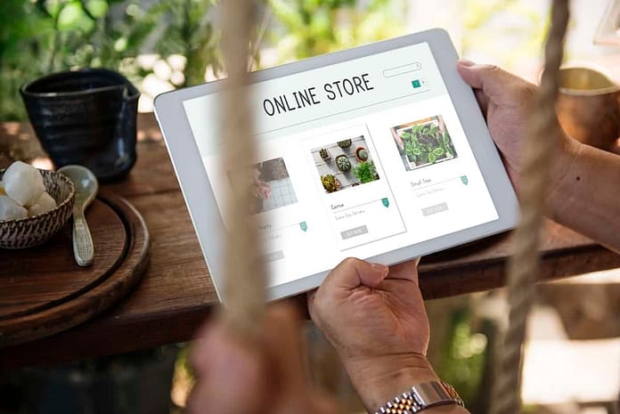 Image of man holding tablet with "Online Store" on it