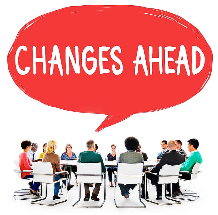Round table of people with a callout "Changes Ahead" - Overcome Your Fear Of Change