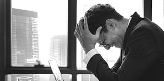 frustrated man at his desk - Reasons Preventing You From Being More Successful