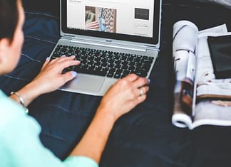 image over the shoulder of a woman blogging