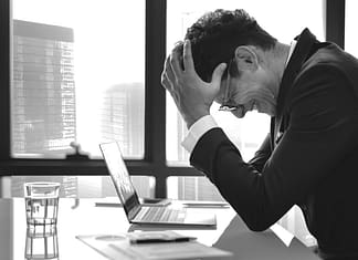 frustrated man at his desk - Reasons Preventing You From Being More Successful