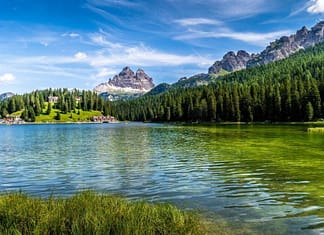 Gorgeous stock photo of river bordered by a mountain chain